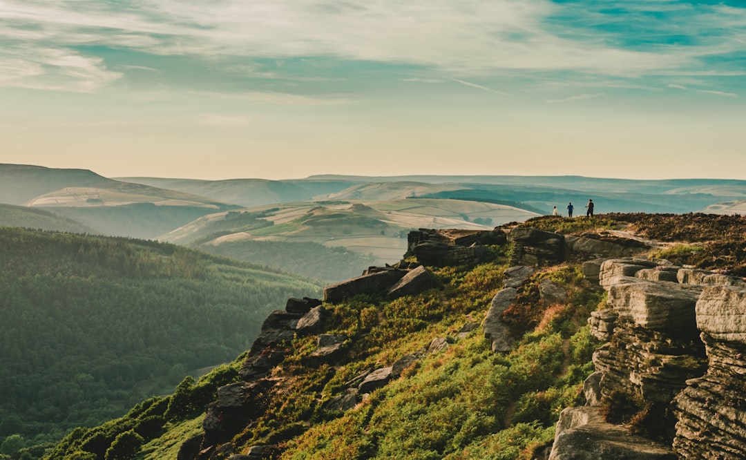 people standing on rock formation during daytime