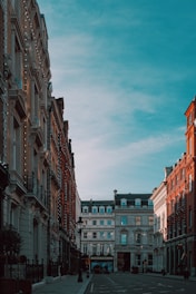 brown and white concrete buildings under white clouds during daytime