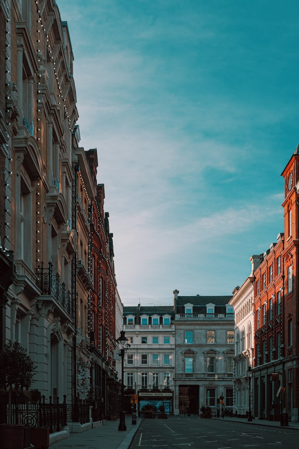 brown and white concrete buildings under white clouds during daytime