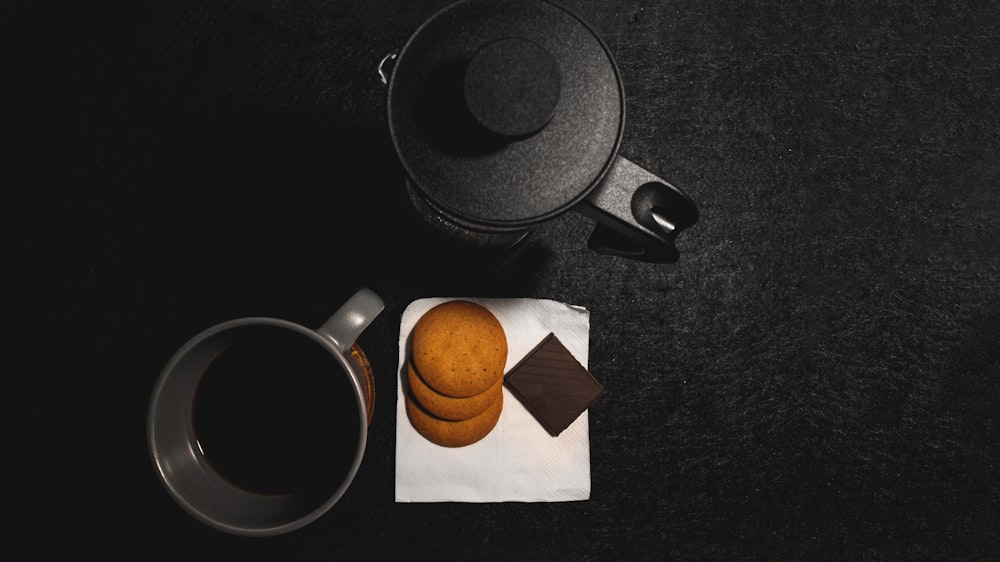 black ceramic mug on white paper