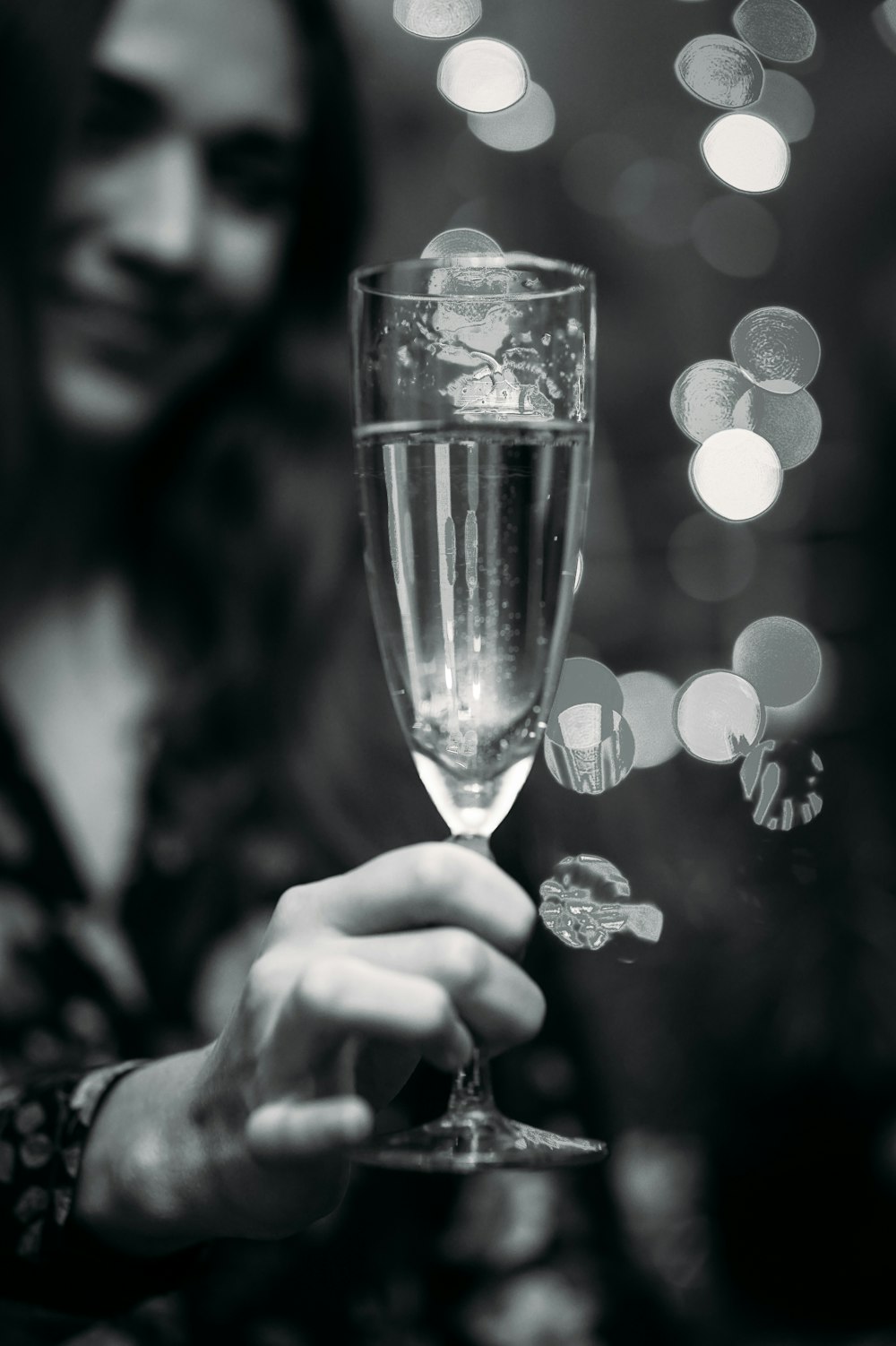 person holding clear wine glass