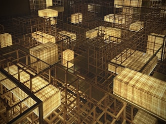 A complex structure of wooden grids is illuminated by rectangular light fixtures. The lights are embedded within the wooden lattice, casting a warm, inviting glow that highlights the intricate geometric design. The arrangement creates an abstract, almost futuristic atmosphere.