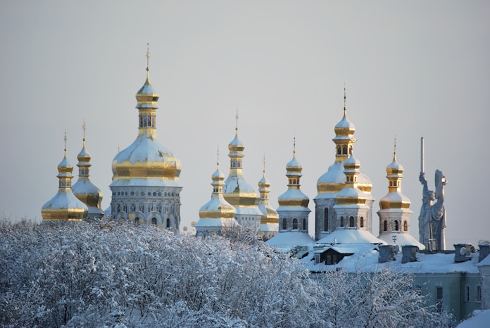 white and gold dome building covered with snow