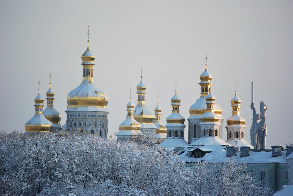 white and gold dome building covered with snow