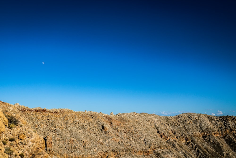 brown rocky mountain under blue sky during daytime