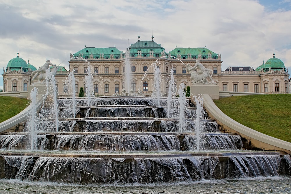 fontaine d’eau devant un bâtiment en béton blanc