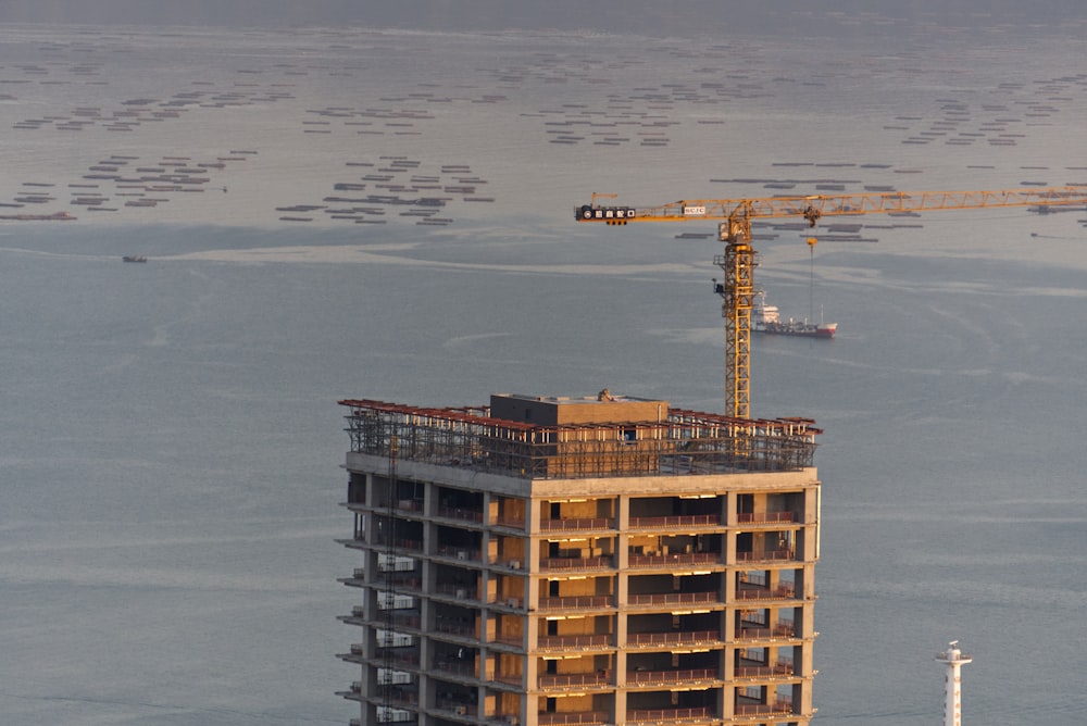 brown concrete building near body of water during daytime