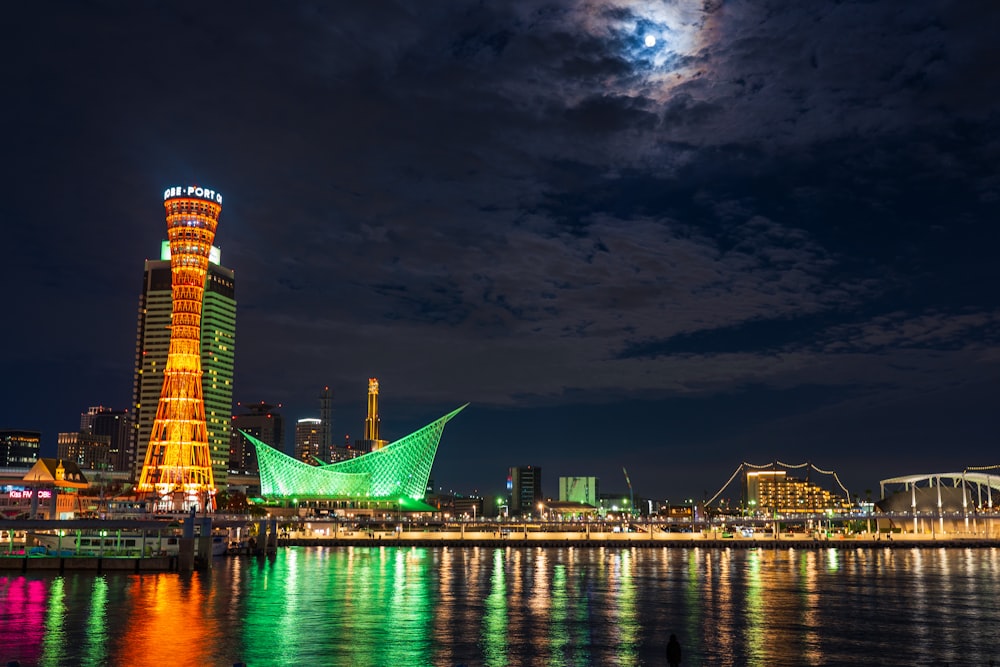 brown high rise building near body of water during night time