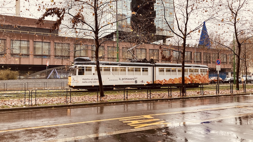 white and red train on rail road