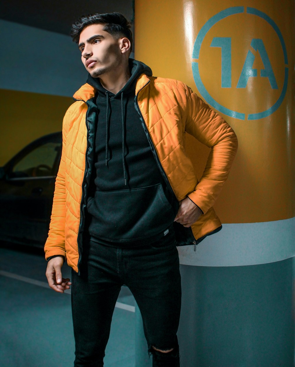 man in yellow zip up jacket and black pants