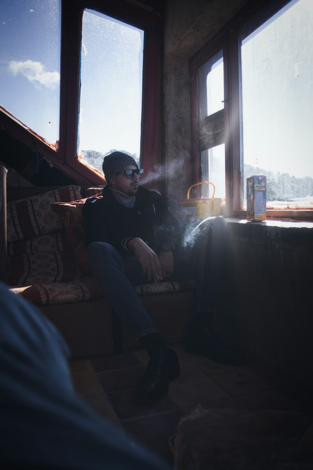 man in black jacket sitting on black couch