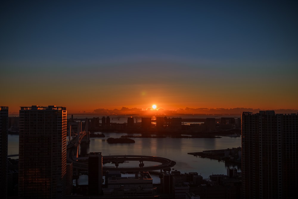 silhouette of city buildings during sunset