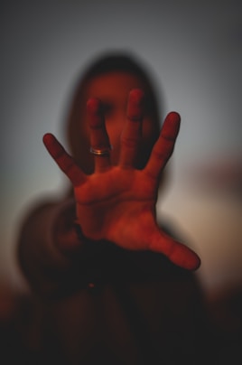 persons left hand with gold ring