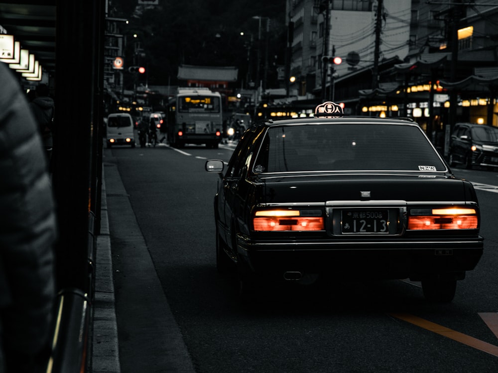 black car on road during night time