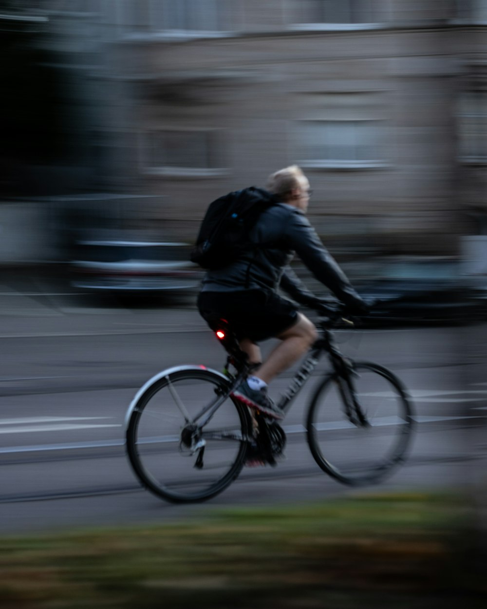 man in black jacket riding bicycle