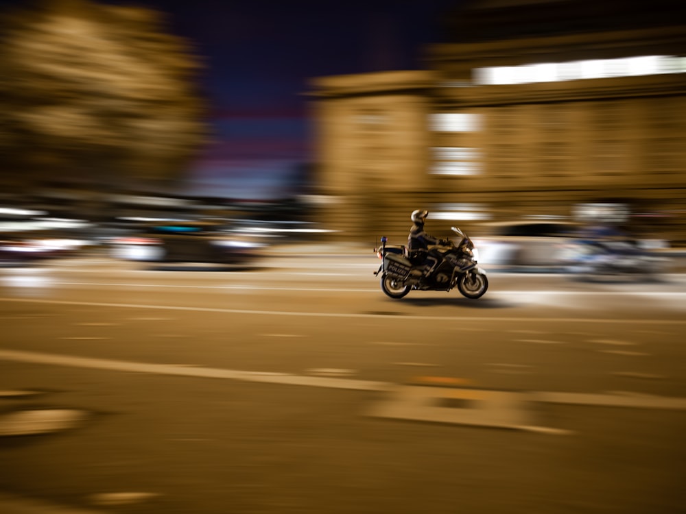 time lapse photography of man riding motorcycle
