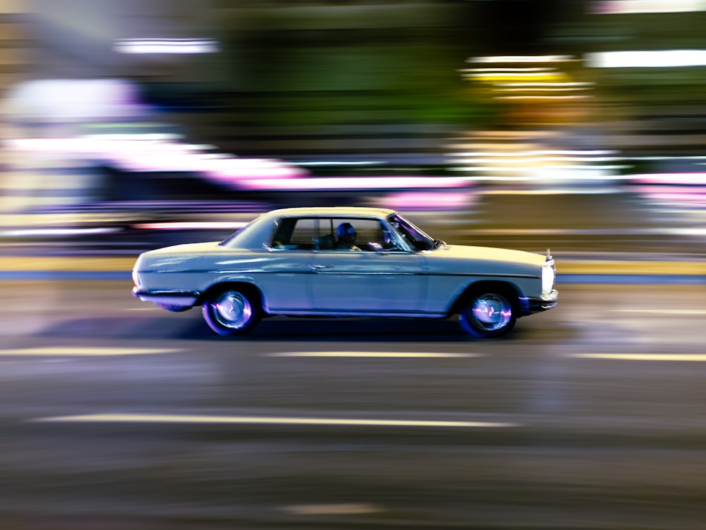 time lapse photography of white sedan on road during daytime