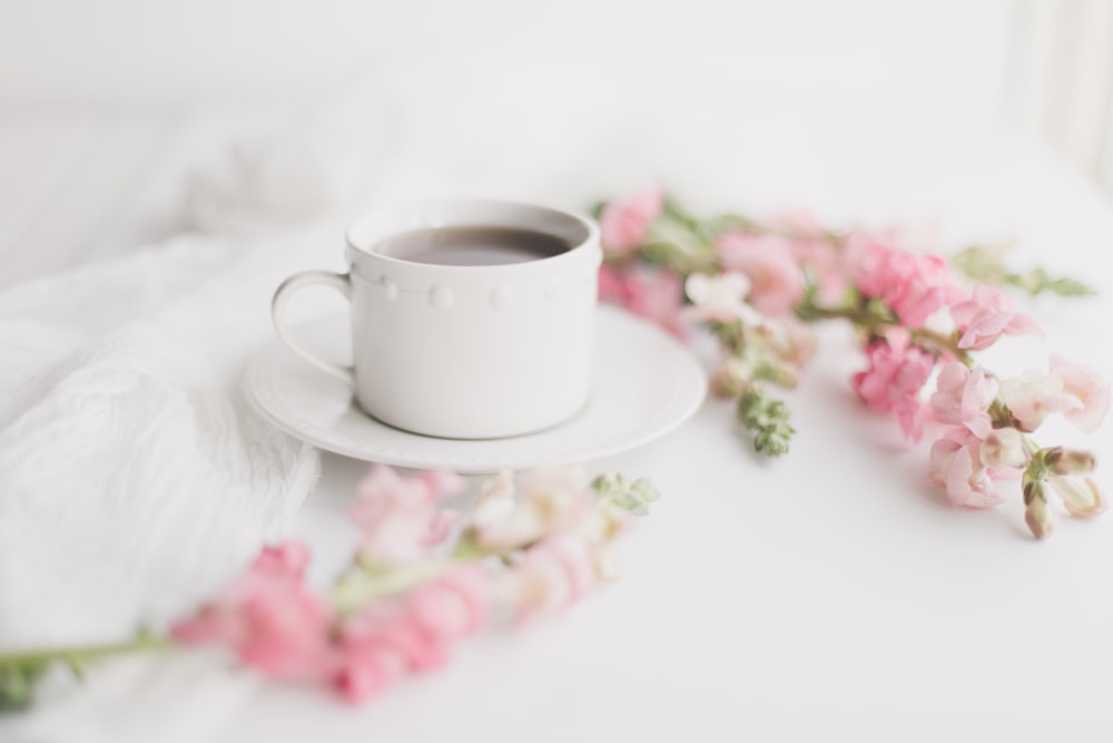 white ceramic cup on white ceramic saucer