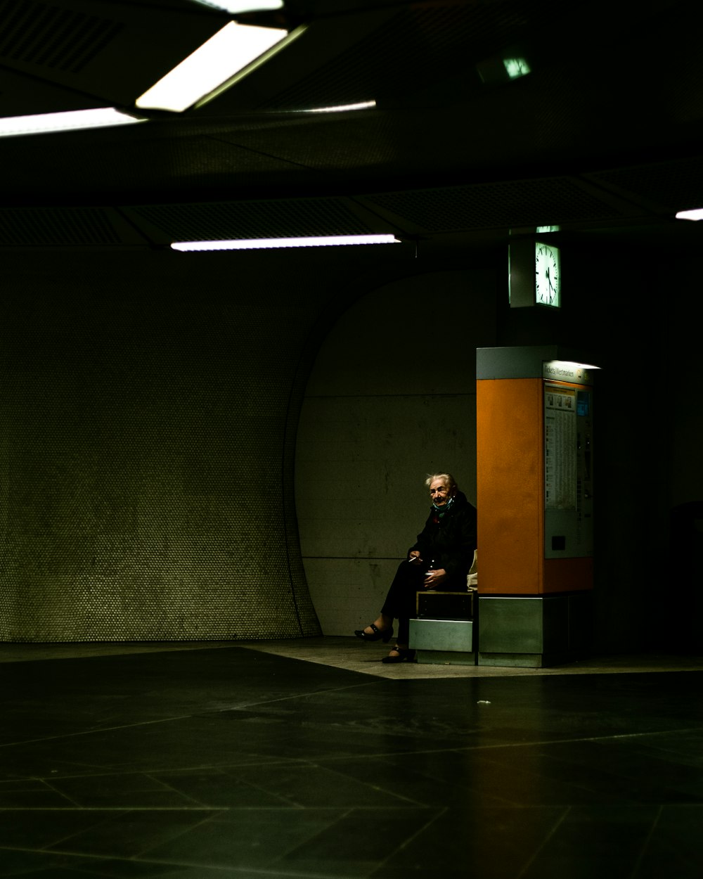 woman in black dress walking on hallway