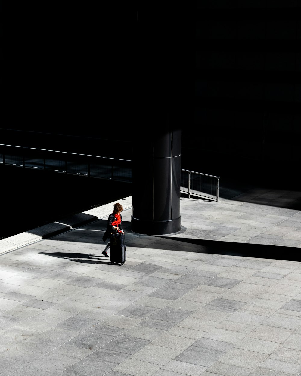 person in black jacket and black pants sitting on bench