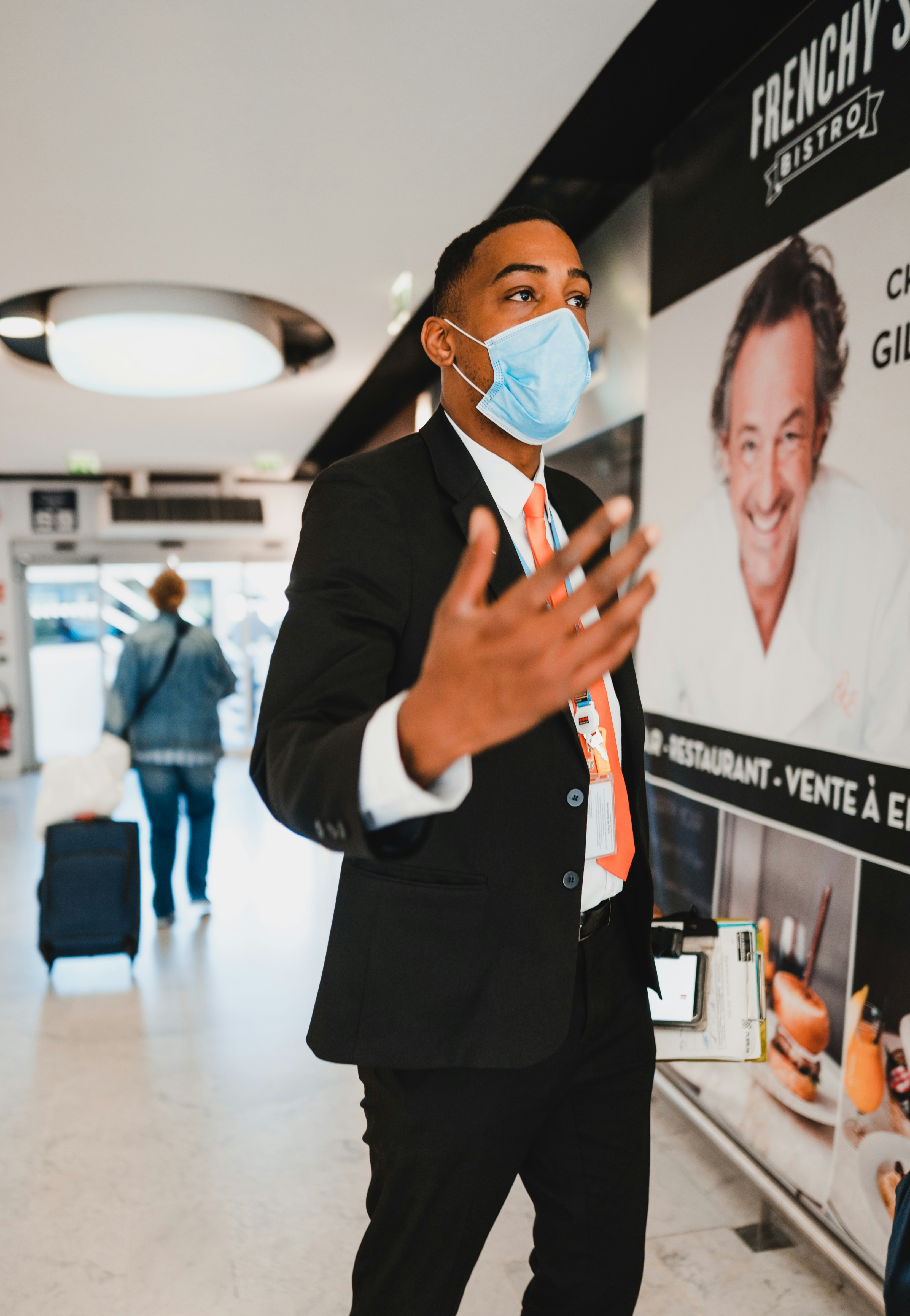 Man in black blazer holding white paper - paris airport transport