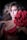 A woman poses dramatically against a dark background, wearing a red lingerie set with ruffled details. She has voluminous, wavy hair and striking makeup, including bold eye shadow. Her expression is intense, and she holds a large red flower that adds to the dramatic aesthetic.