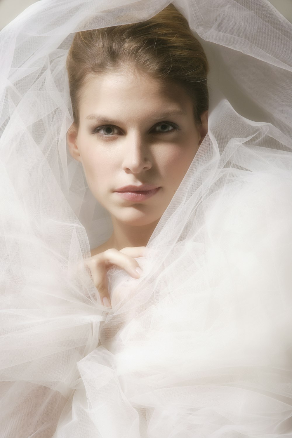 woman in white veil on white sheer textile