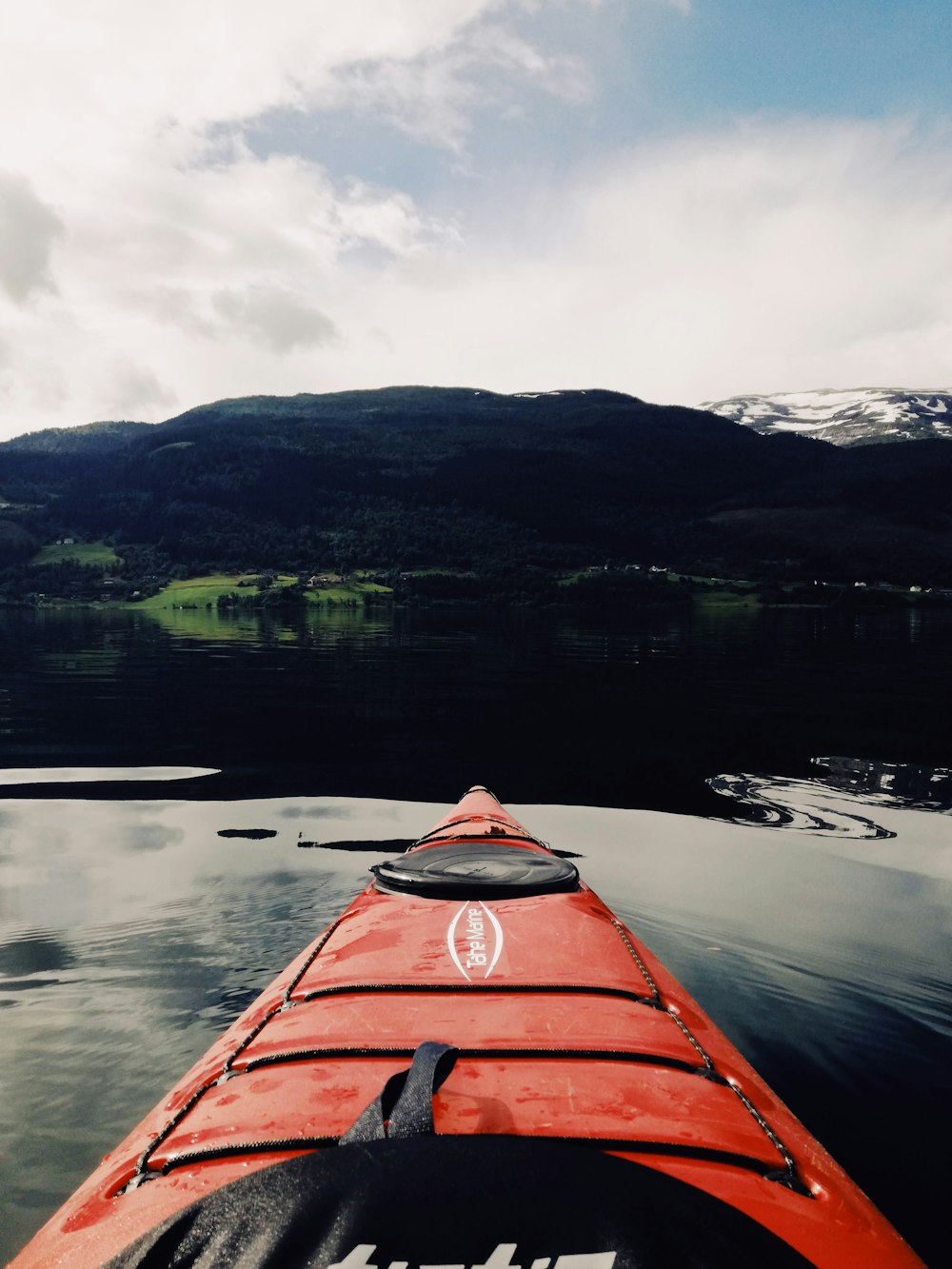 Person im roten Kajak tagsüber auf dem See