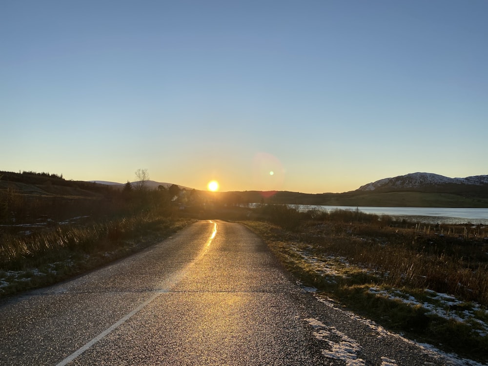 gray asphalt road during sunset