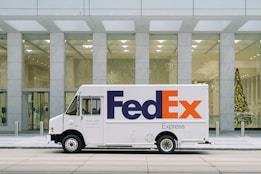 white van parked near white concrete building