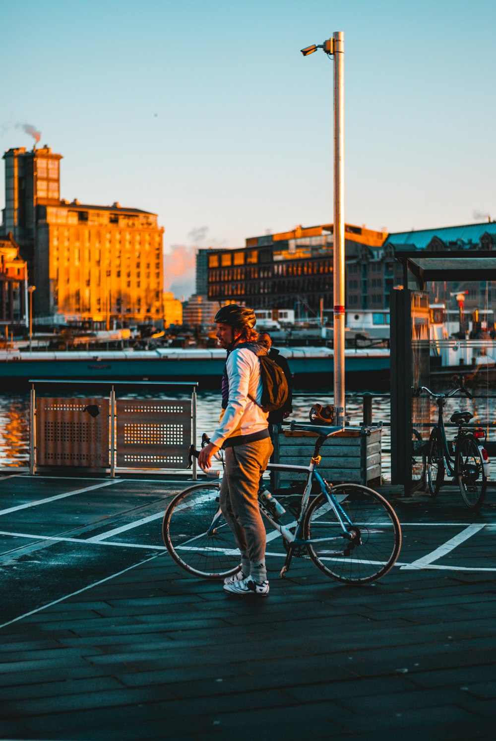 man in blue and white plaid dress shirt riding on bicycle during daytime