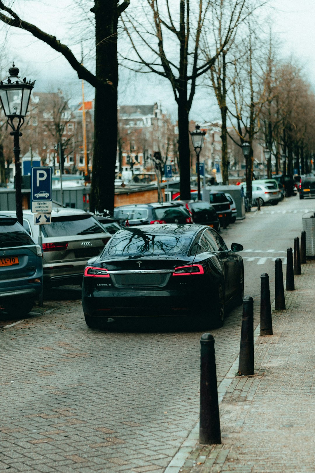 black porsche 911 parked on sidewalk during daytime