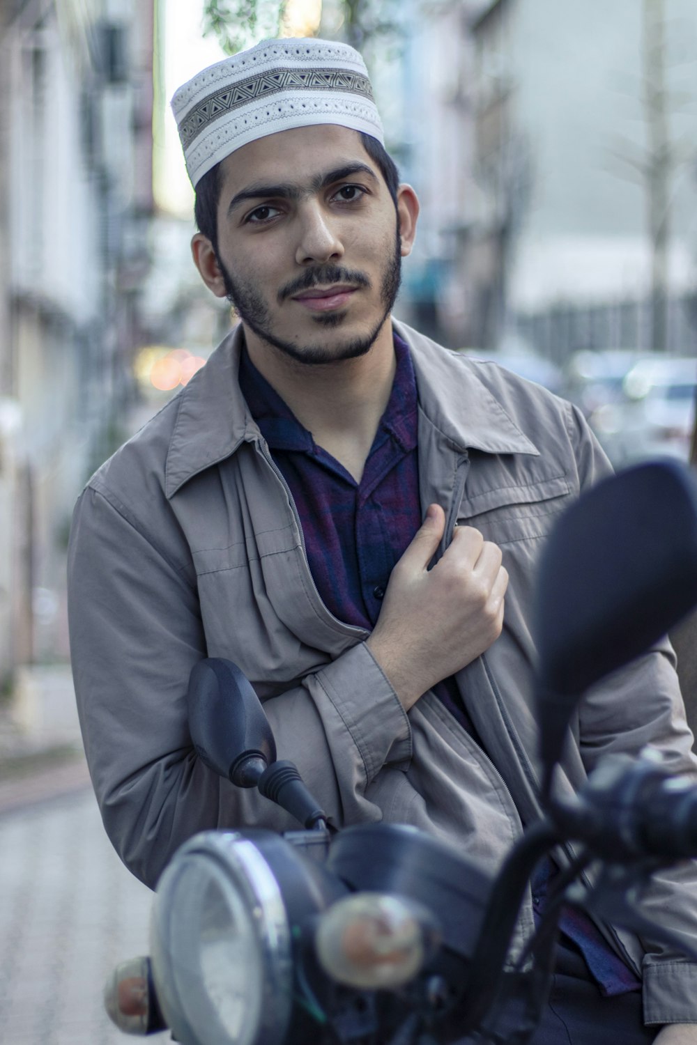 man in brown coat sitting on black chair