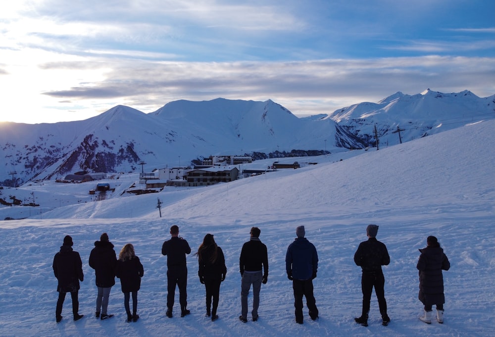 group of people standing on snow covered ground during daytime