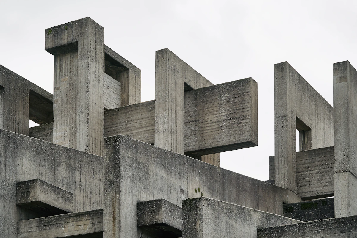 Gray concrete building viewed against a pale sky.