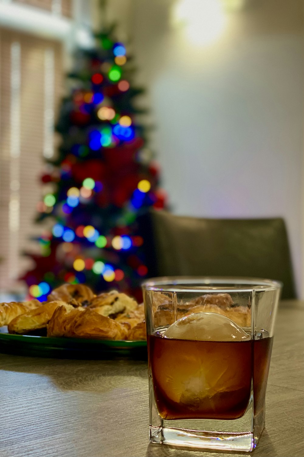 clear drinking glass with brown liquid inside