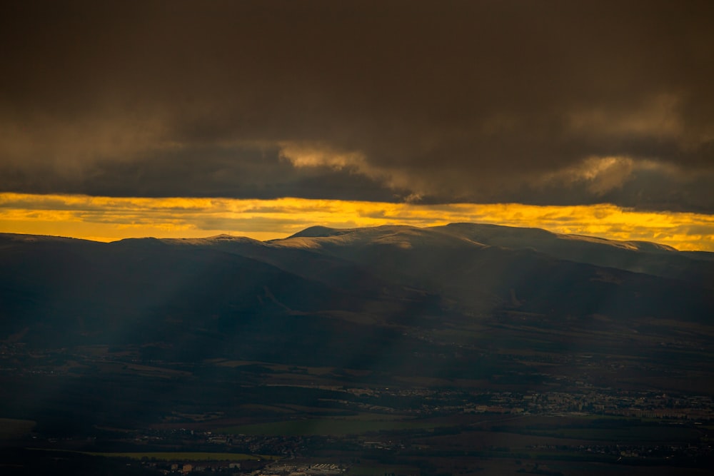 white clouds over mountains during daytime