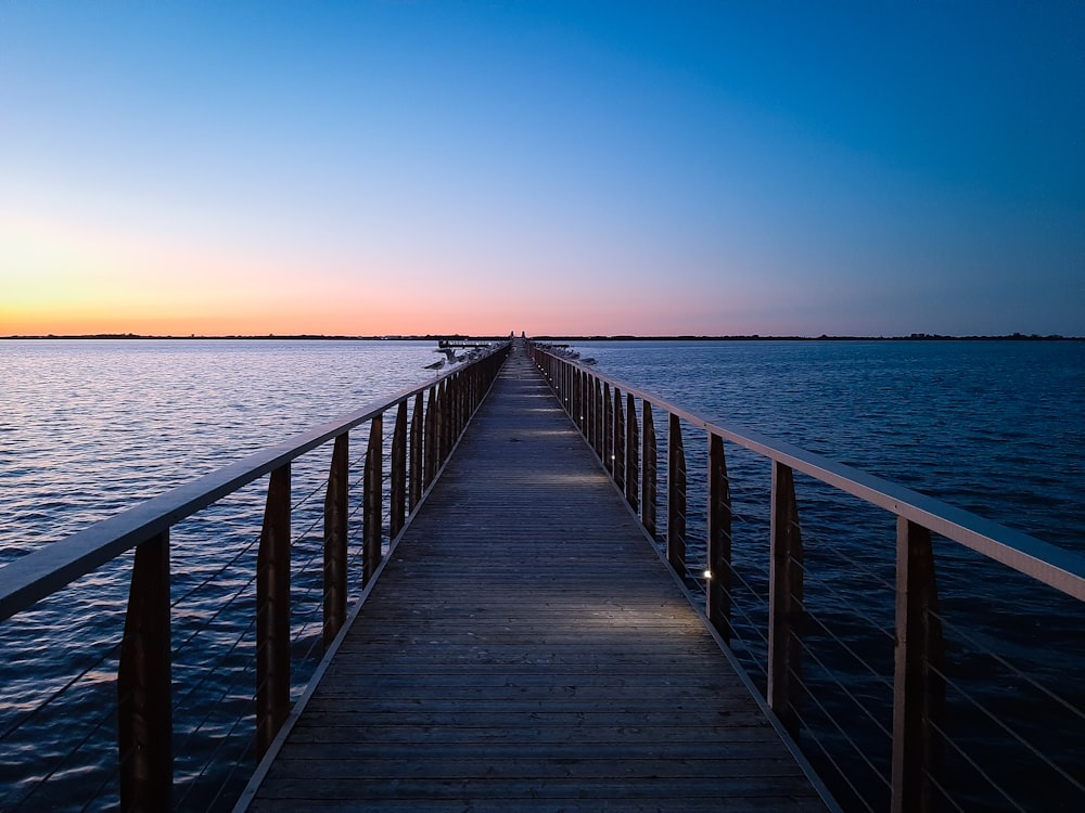 brown wooden dock on sea during daytime