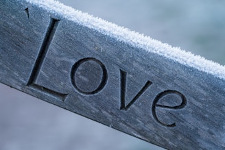 silver love embossed ornament on white textile