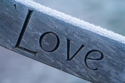 silver love embossed ornament on white textile