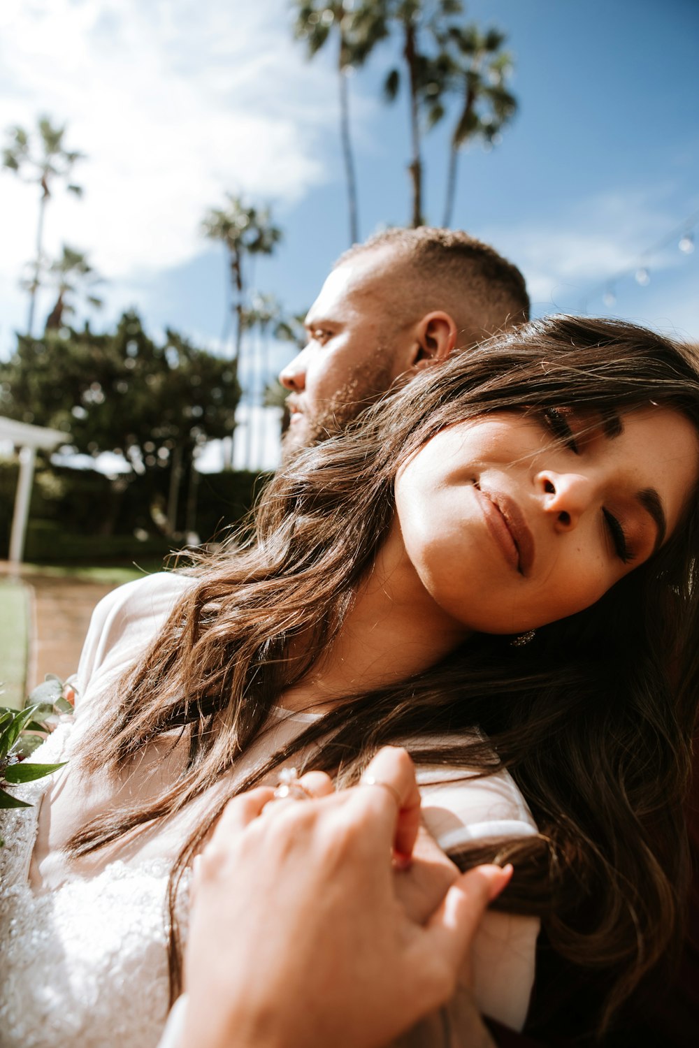 man and woman kissing under blue sky during daytime