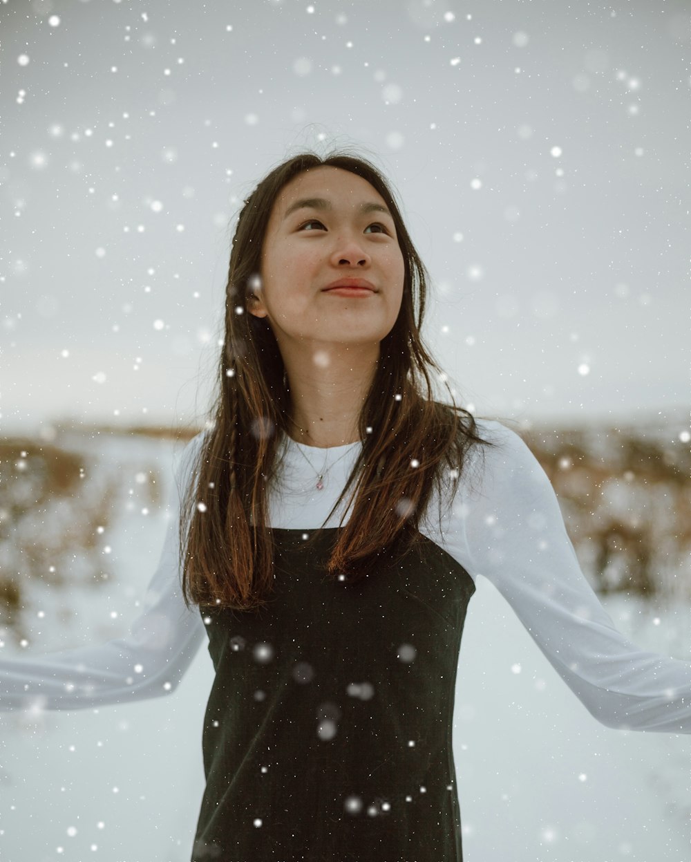 woman in black turtleneck long sleeve shirt standing on snow covered ground during daytime