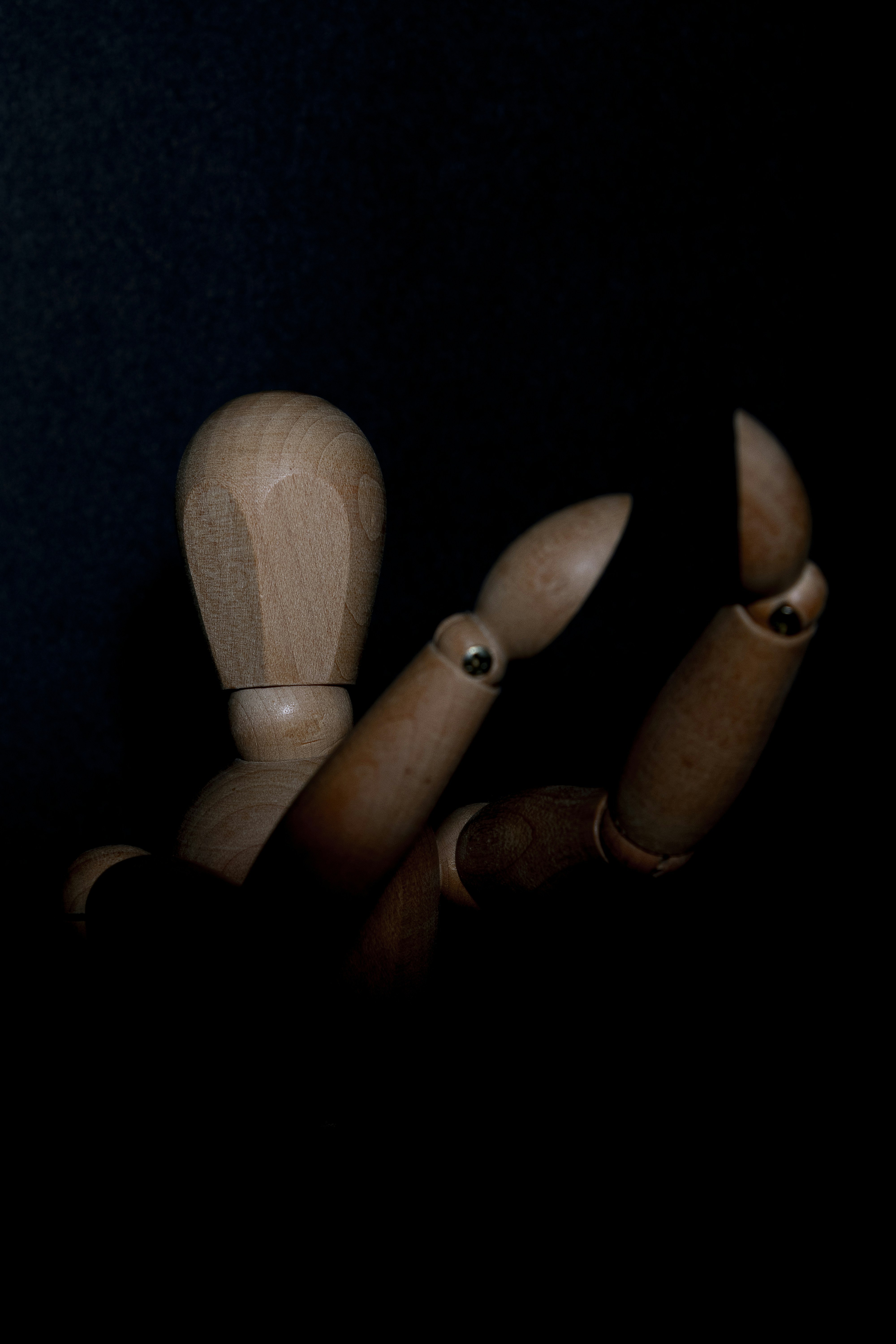 brown wooden rolling pin on black textile