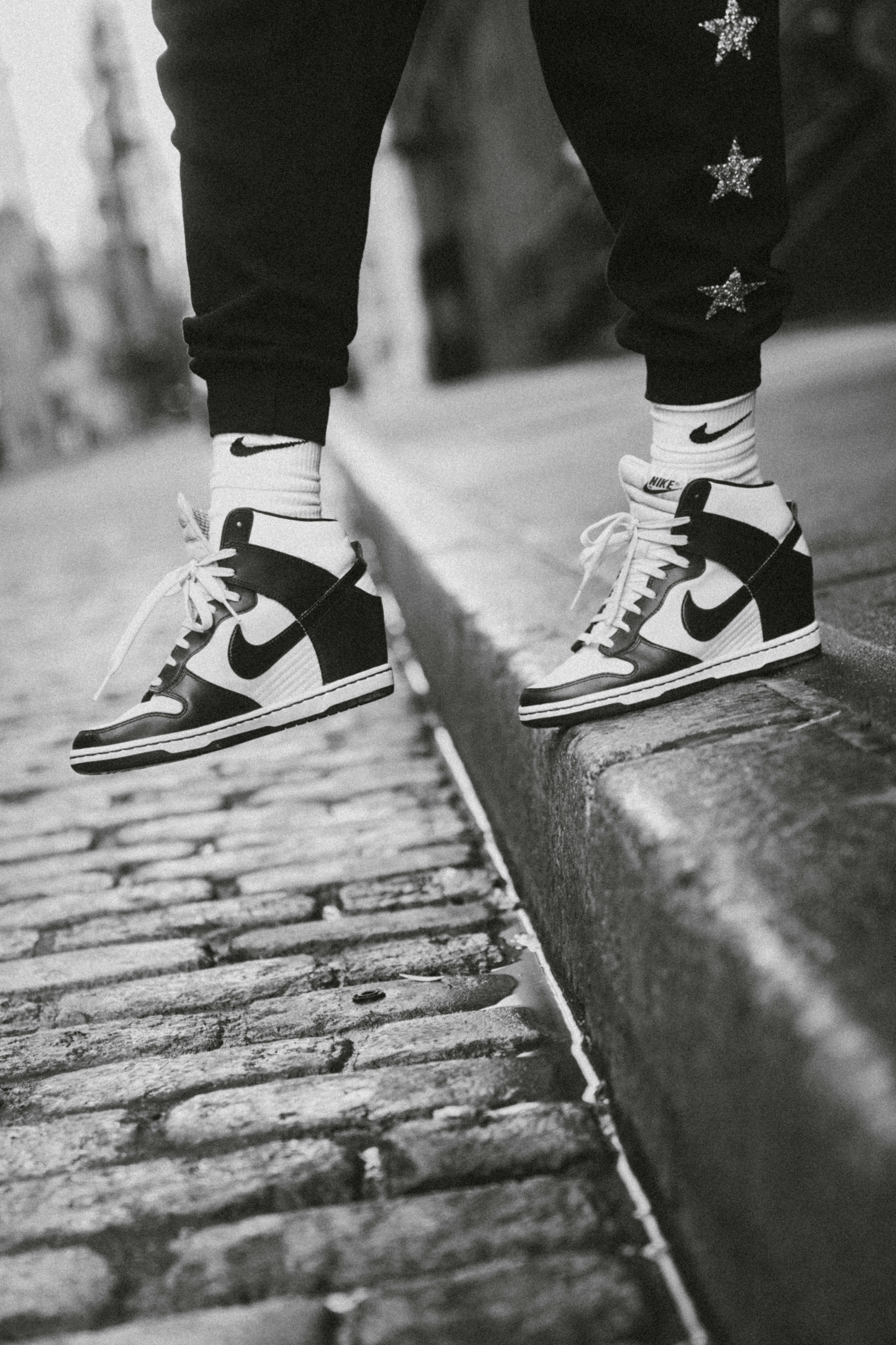 person in black and white nike sneakers