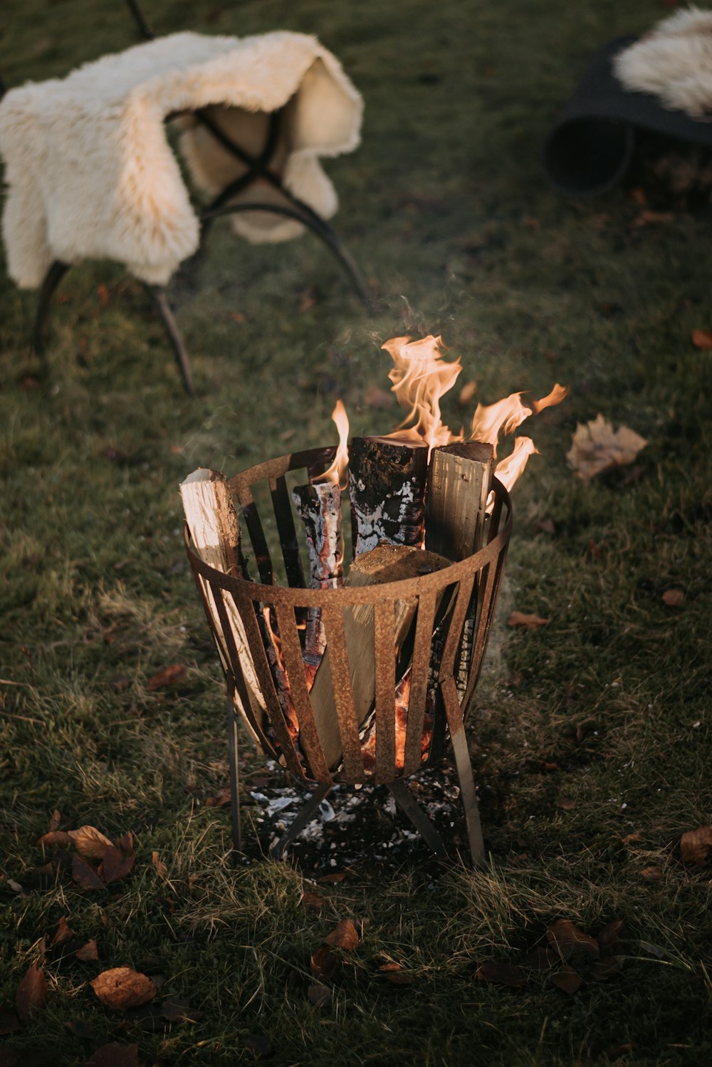 brown fire pit on green grass field during daytime