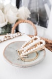 gold necklace on white ceramic plate