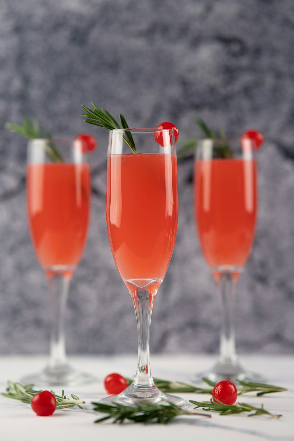 3 clear wine glasses with red liquid