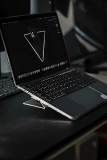A sleek laptop with a cyberpunk-themed wallpaper on the screen.