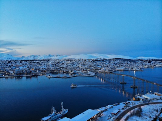 Aerial view of city buildings near body of water during daytime — Tromsø, Norway