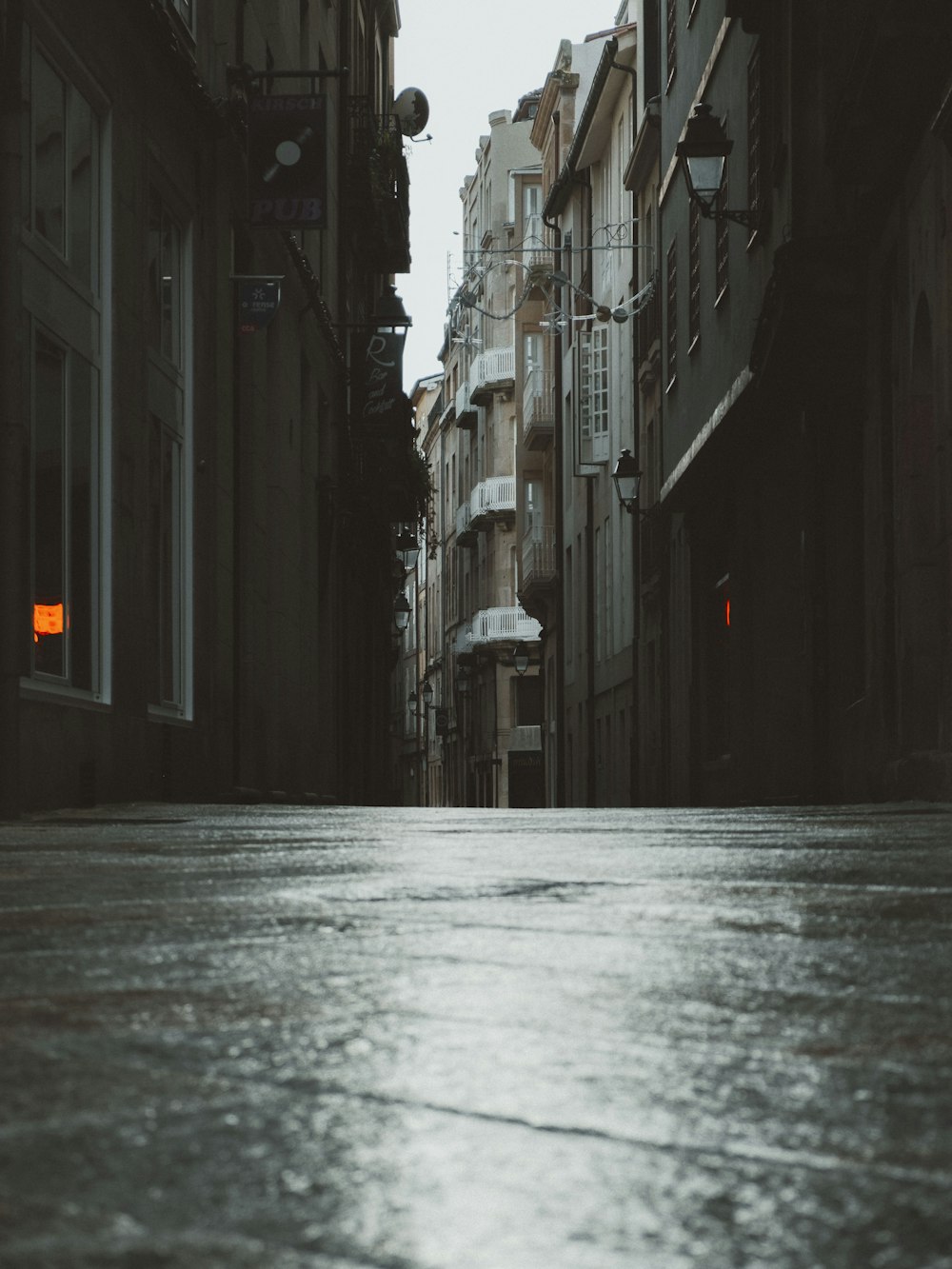 empty street between buildings during daytime